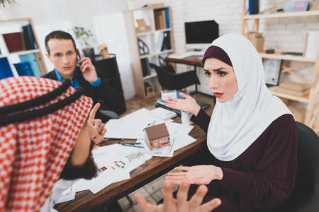 An arab woman is looking at an arab man.の写真素材