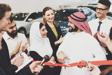 Arab man looks at a woman who is standing nearby.