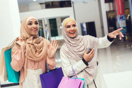 Young Arabian Women with Packages Standing in Mallの写真素材