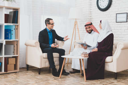 Arab people sit in office with a contract.の写真素材