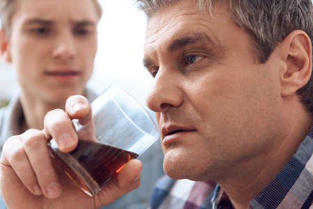 A man with a glass of alcohol.