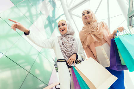 Young Arabian Women with Packages Standing in Mallの写真素材