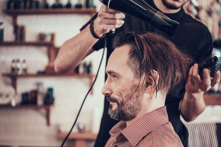 The hairdresser stands near the client.の写真素材