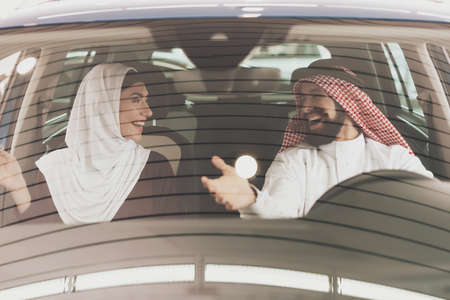 Man and his wife are trying out new car.の写真素材