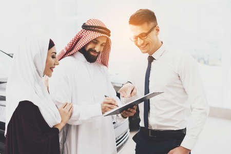 Arab smiles while puts a signature on purchase.の写真素材