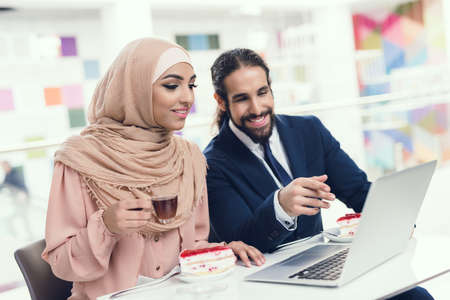 Arabian Couple Sitting in Cafe after Shopping.
