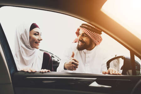 Arab looks at his wife and shows a gesture super.の写真素材
