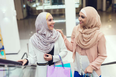 Young Arabian Women with Packages Standing in Mallの写真素材