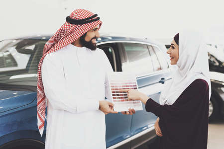 Arabs stand in a car shop and choose a color.の写真素材