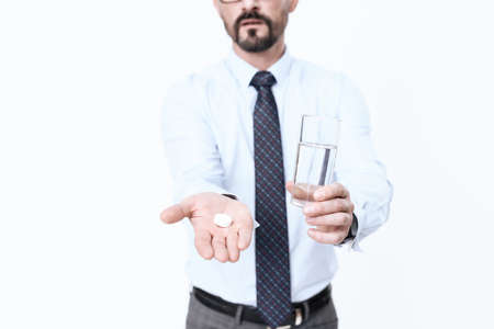 A man with a glass of water and a tablet.の写真素材