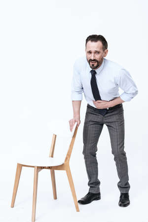 A man in a shirt looks at the camera.