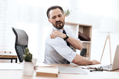 A man in a shirt suffers from severe pain.