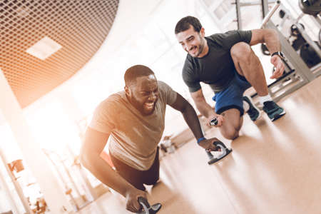 A man is doing exercises in a modern gym.の写真素材