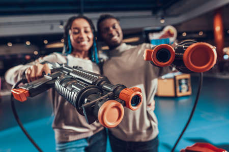 African american couple with guns in arcade.の写真素材