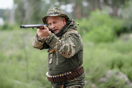 Bird Hunt Concept Old Man Taking Aim with Rifle.