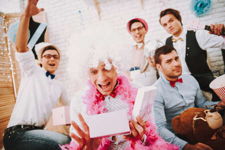 Gay guys opening presents at party.の写真素材
