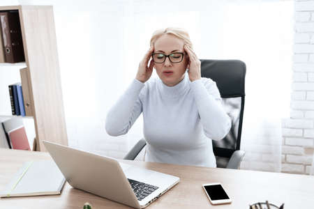 A brunette woman has a headache.の写真素材