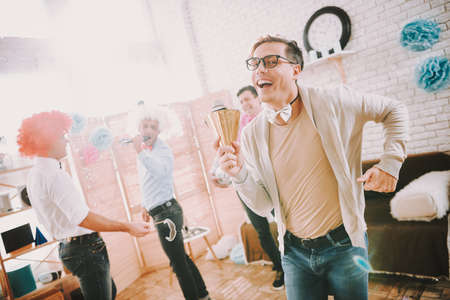 Gay man smiling at camera and dancing at gay partyの写真素材