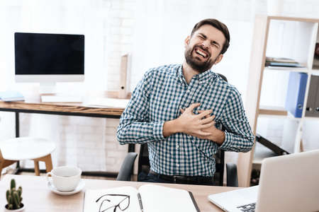 Man grabbed his heart and feels severe pain.の写真素材