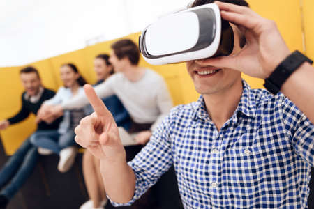 Happy intelligent man looks into virtual glasses.の写真素材