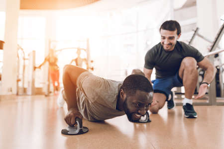 A man is doing exercises in a modern gym.の写真素材
