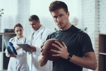 Male basketball player stands in the office.の写真素材