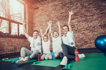 Sport Family Sit On Gym Carpet During A Break.の写真素材