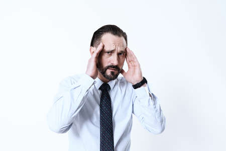 A man in tie and shirt stands with suffering face.の写真素材