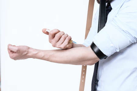 Man makes an injection in his hand.の写真素材