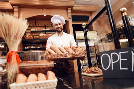 Young Bearded Man in Apron Standing in Bakery.の写真素材