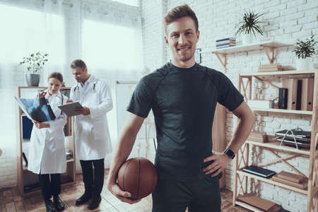 Man basketball player stands in the office.の写真素材