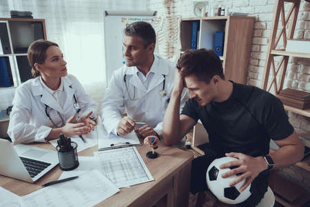 Male and female doctors with stethoscope in officeの写真素材