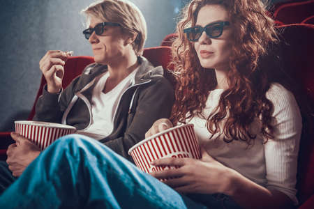 Beautiful woman with a man sitting in the cinema.