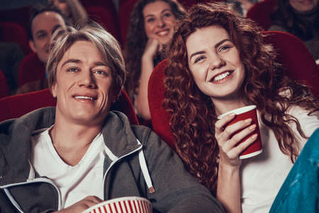 Close-ups of men and women watching a movie.の写真素材