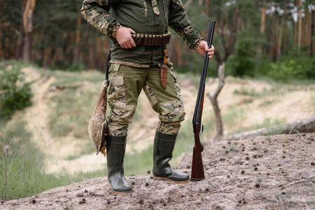 Hunter in Rubber Boots Shells on Belt Bird Hunt.の写真素材
