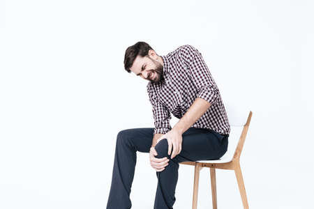 A young man has a pain in his leg.