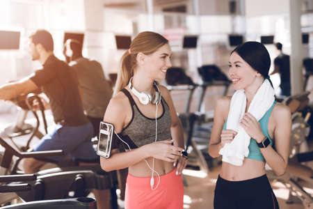 Girls smiling and talking to each other at gym.の写真素材