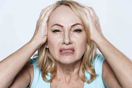 Close shot of a girl who suffers from a headache.の写真素材