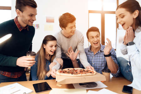 Group of young happy people eating pizza.の写真素材
