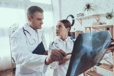 Male doctor looks menacingly at intern woman.の写真素材