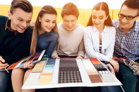 People sit and look at colors to choose a design.の写真素材
