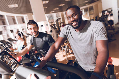 Two man in the gym smiling at the camera.の写真素材