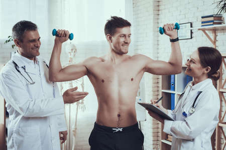 Athlete showing his physical form to doctors.の写真素材