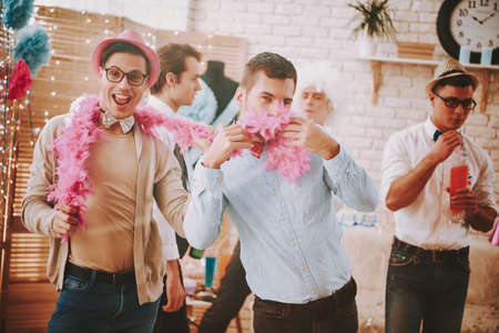 A man covers his mouth with a pink scarf.の写真素材