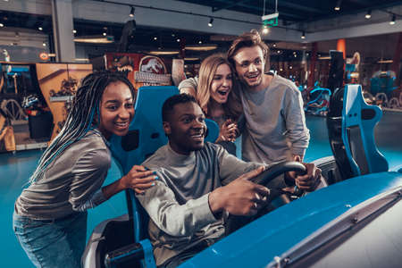 Black man smiling and driving car in playroom.の写真素材