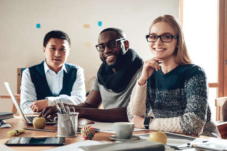 Woman with colleagues sitting at the table.の写真素材