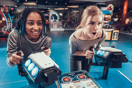 Young girls enthusiastically play video games.の写真素材