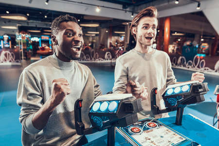 A black man stands with guy and plays star wars.の写真素材