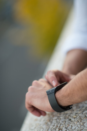Man with Mobile phone connected to a smart watch, close-up handsの写真素材