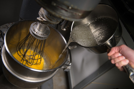 Whipping eggs with a metal whisk in a pastry
